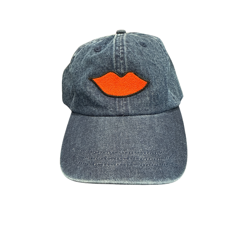 Denim cap with orange lips on a white background