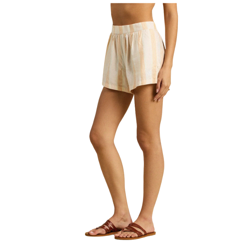 Person wearing beige plaid shorts on a white background