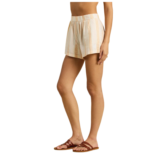 Person wearing beige plaid shorts on a white background