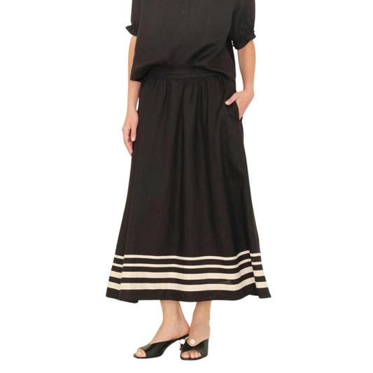 Black dress with a striped hem on a white background