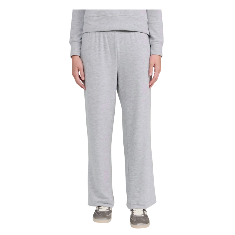 Person wearing gray sweatpants and a matching top on a white background