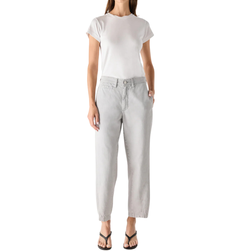 Person wearing a white t-shirt and light gray pants on a white background