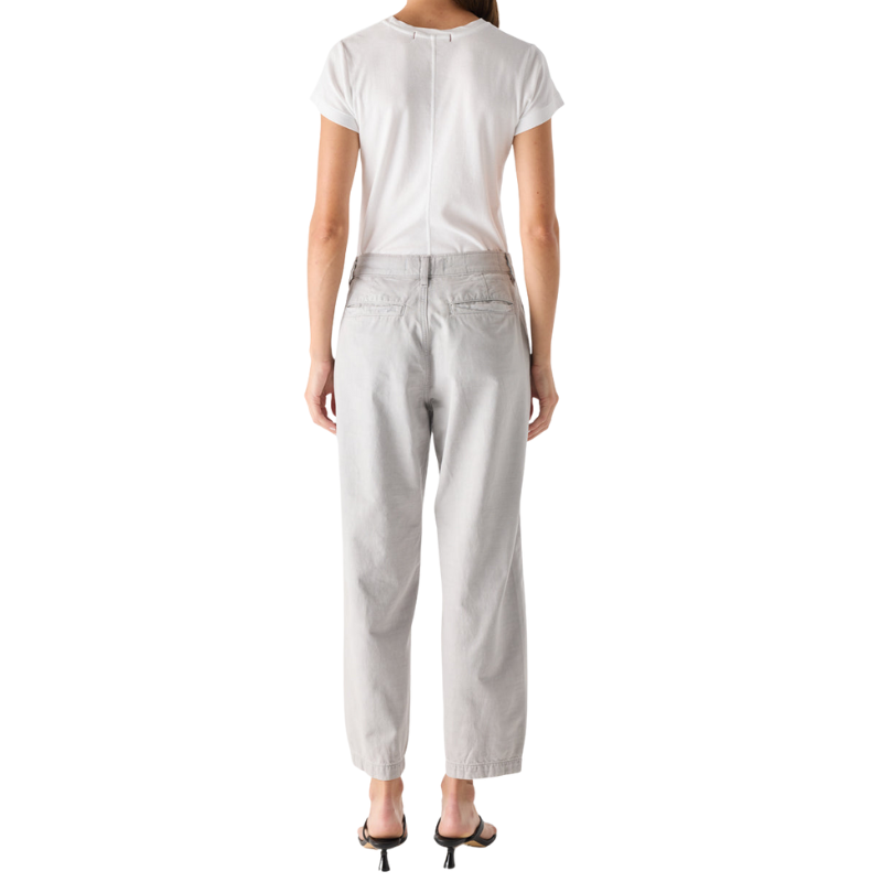 Person wearing a white t-shirt and light gray pants on a white background