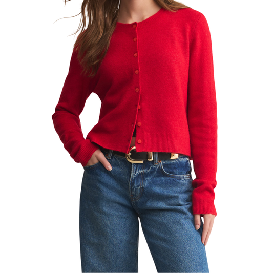 Red cardigan worn by a person on a white background