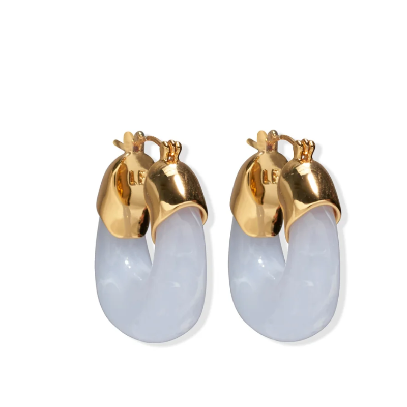 Gold and light blue earrings on a white background