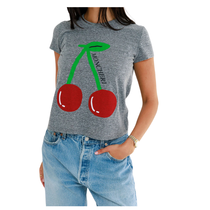 Person wearing a gray t-shirt with red cherries and green leaves design.