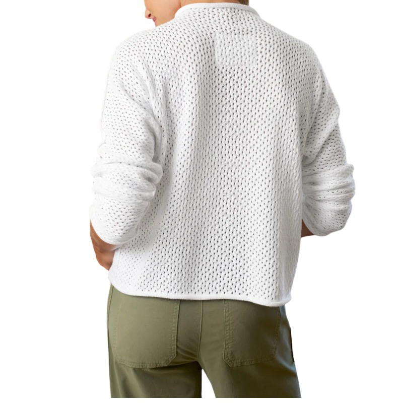 Person wearing a white textured sweater and green pants on a white background