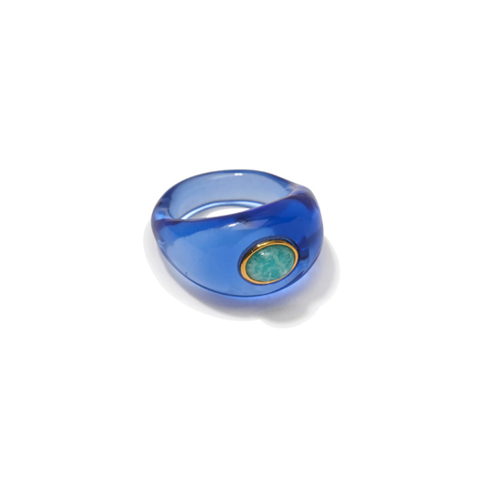 Blue ring with a green gemstone on a white background