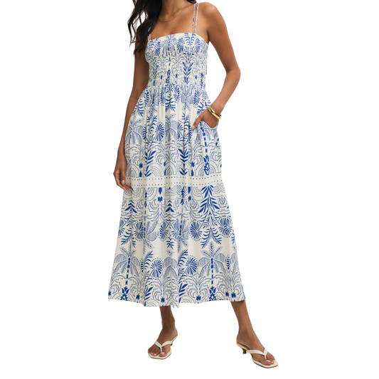 Woman wearing a blue and white floral dress on a white background