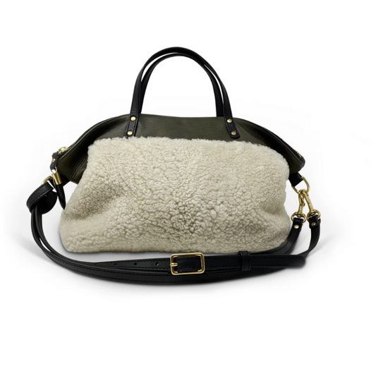 Handbag with shearling liner on a white background