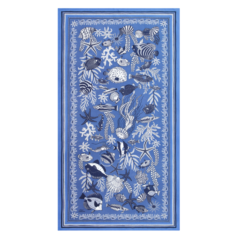 Blue rug with ocean-themed design featuring fish and sea creatures on a white background