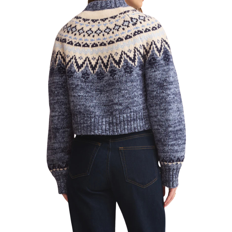 Person wearing a patterned sweater with a white background