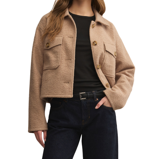 Beige jacket worn by a person on a white background