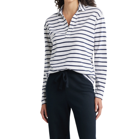 Person wearing a white and navy striped long-sleeve shirt with navy pants on a white background