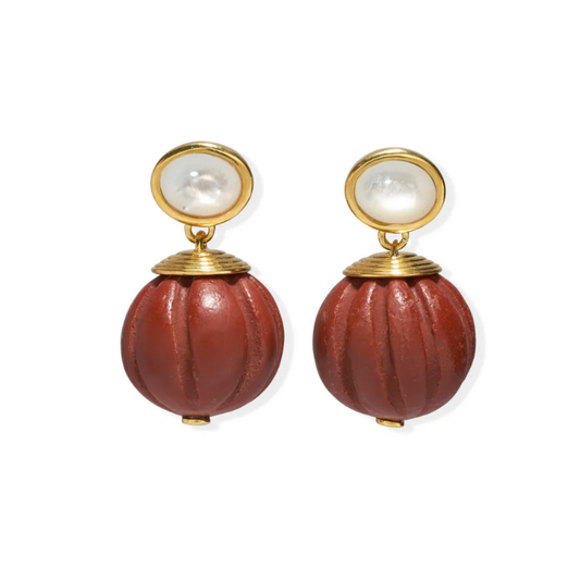 Pair of earrings with red spherical elements and gold accents on a white background