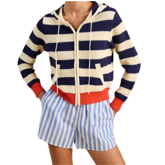 Person wearing a navy and white striped hoodie with red accents and blue and white striped shorts on a white background.