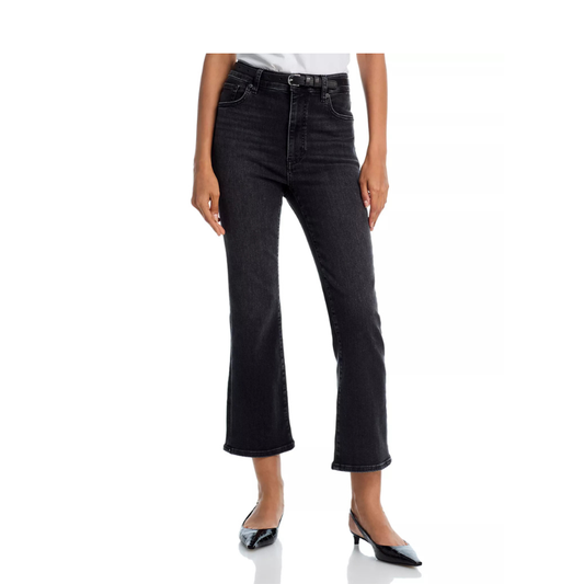 Person wearing black jeans on a white background