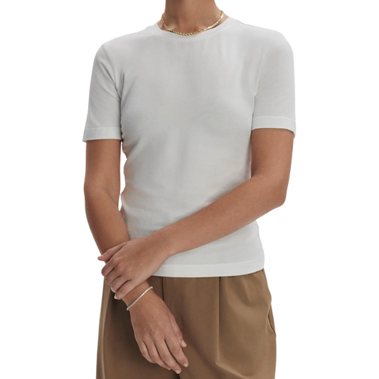 Person wearing a plain white t-shirt and brown pants on a white background