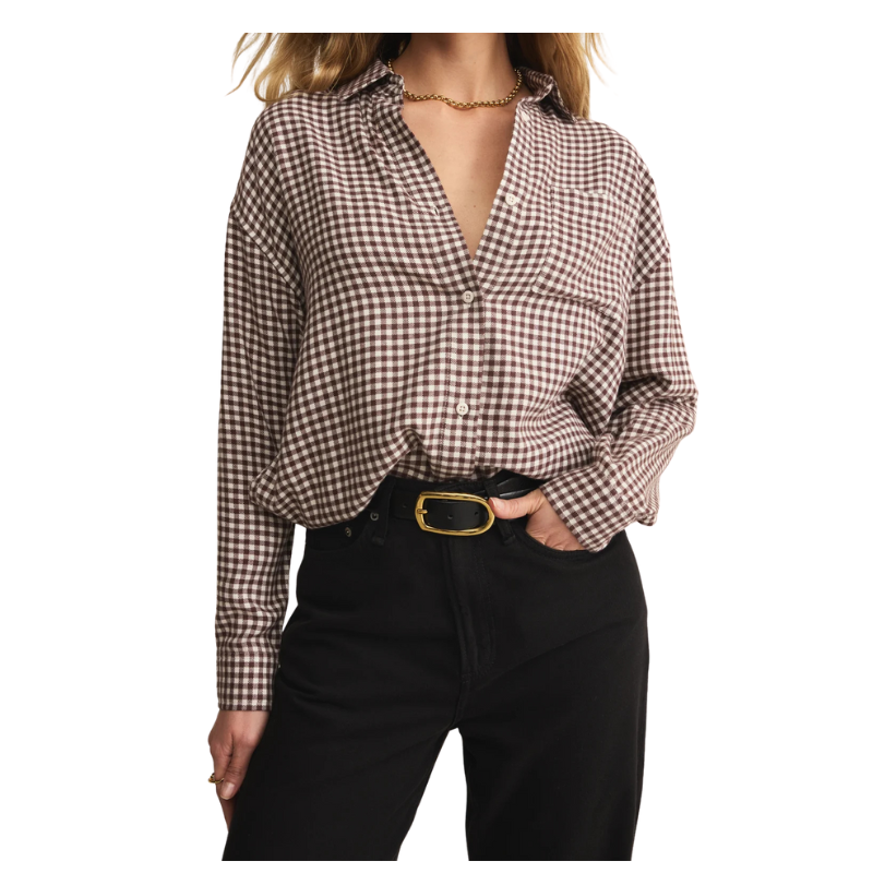 Person wearing a checkered shirt and black pants on a white background