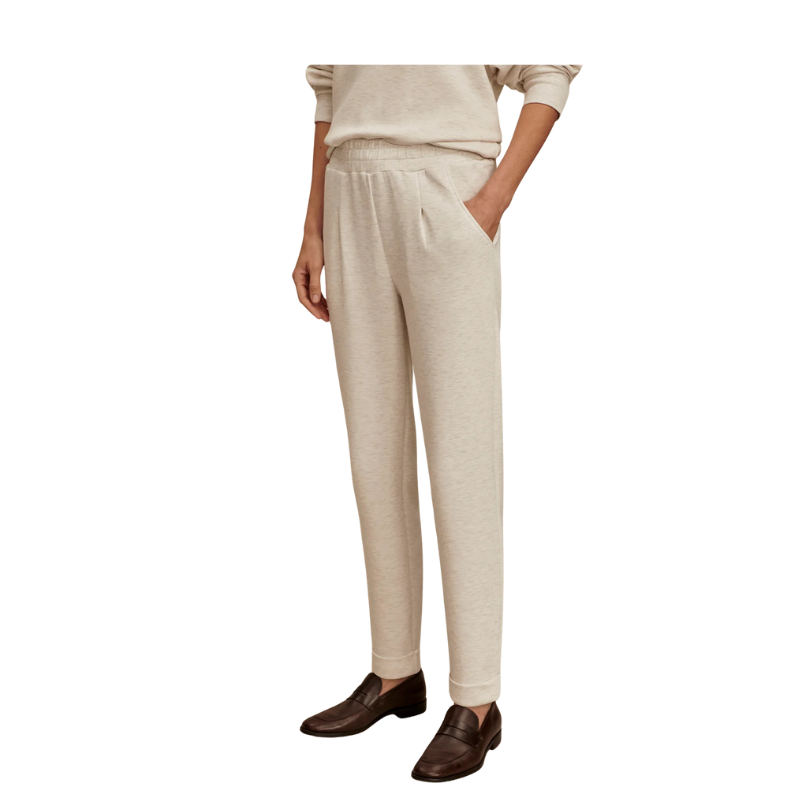 Beige pants worn by a person on a white background
