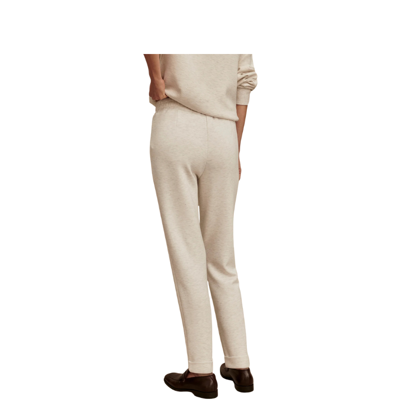 Beige pants worn by a person on a white background