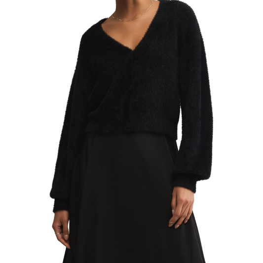 Black sweater and skirt set on a white background