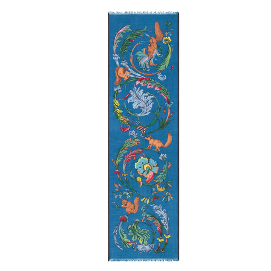 Decorative rug with colorful animal and floral patterns on a blue background