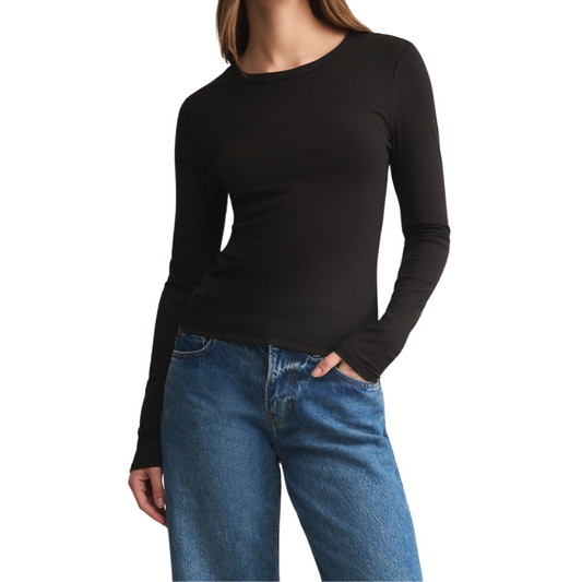 Person wearing a black long-sleeve top and blue jeans on a white background