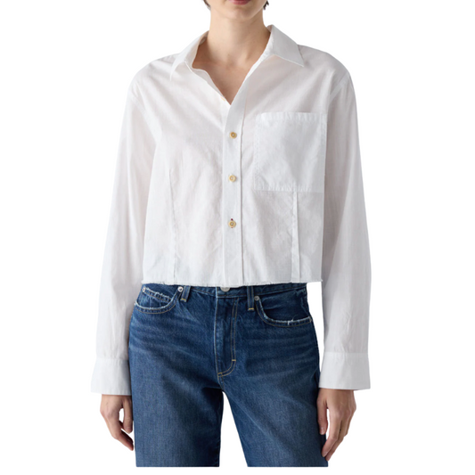 White button-up shirt and blue jeans on a white background