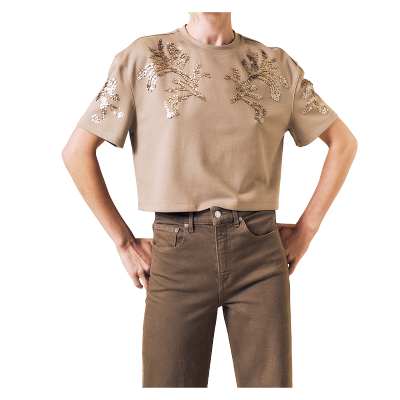 Beige embroidered shirt and brown pants on a white background