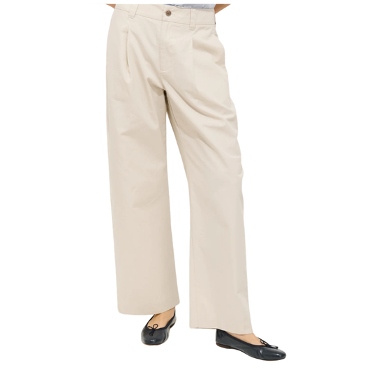 Beige pants worn by a person on a white background