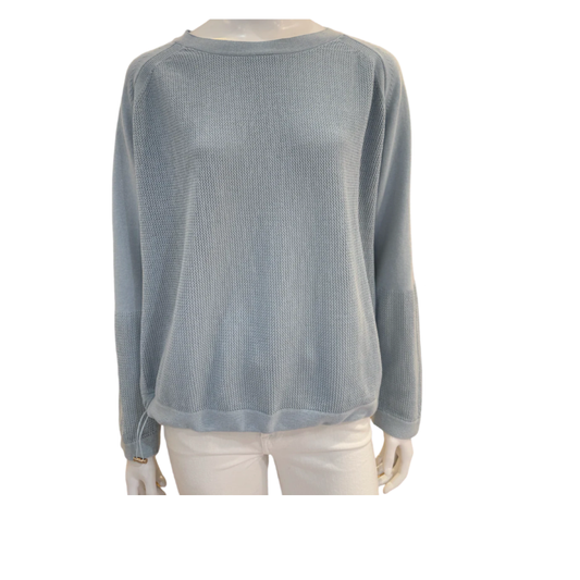 Light blue sweater on a mannequin against a white background