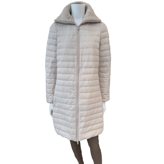 Beige quilted jacket on a mannequin against a white background