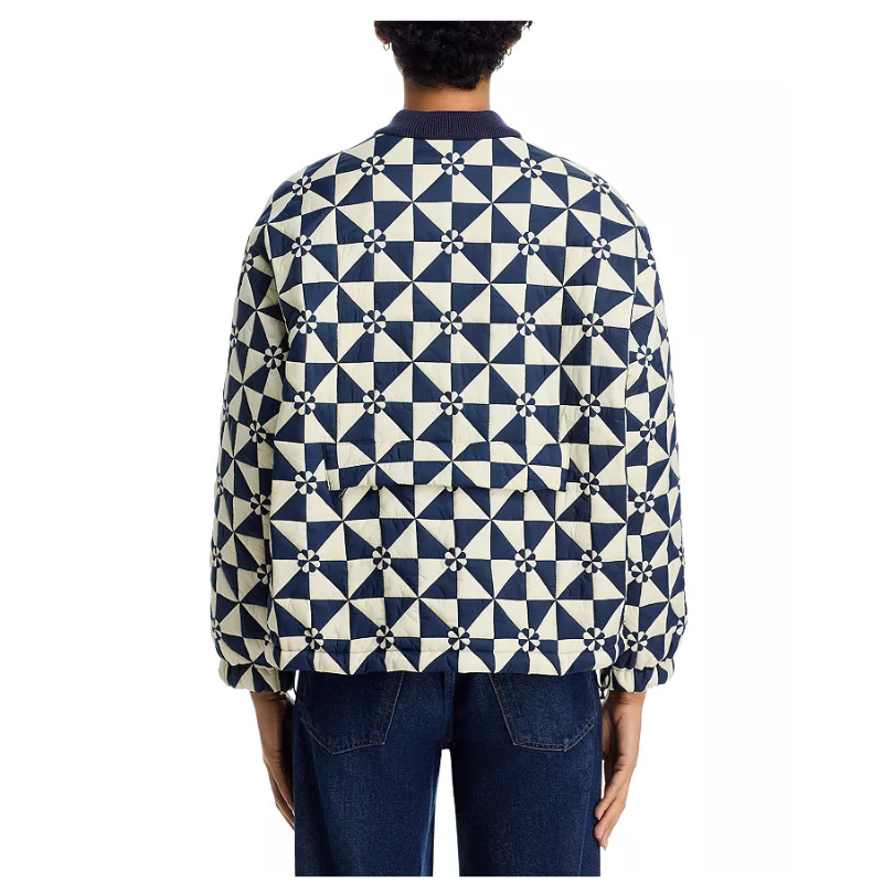 Person wearing a blue and white geometric patterned shirt on a white background