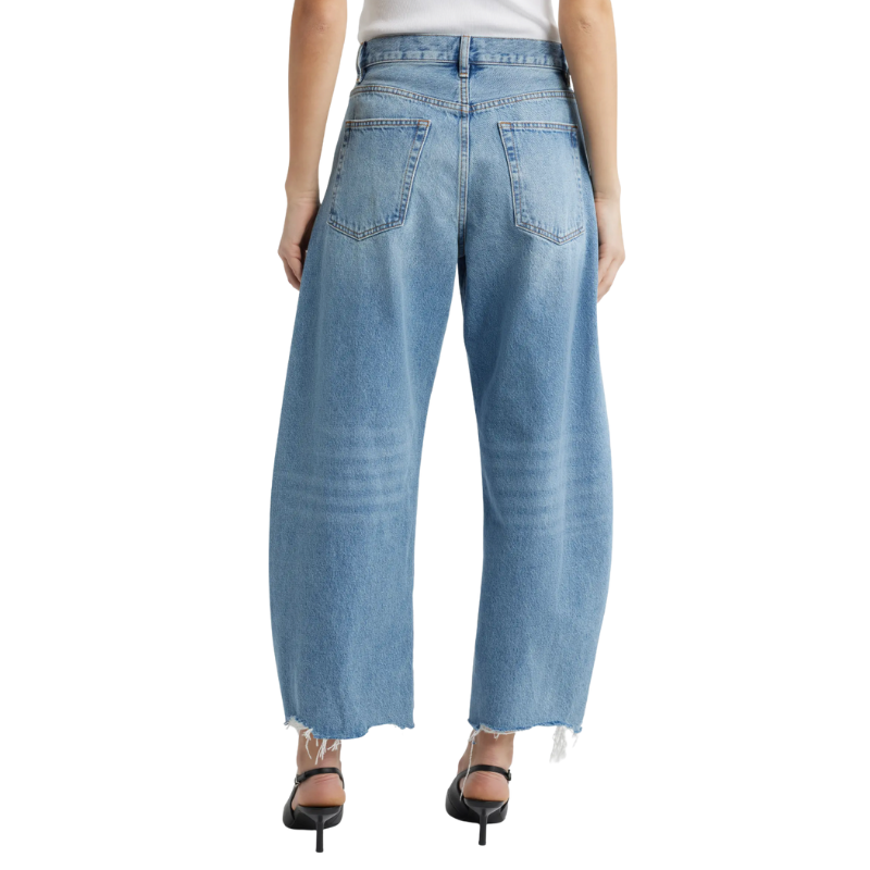 Light blue jeans worn by a person on a white background