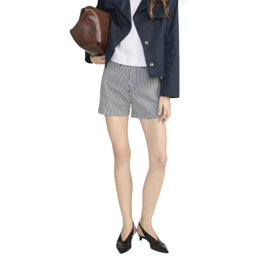 Person wearing a navy jacket, white shirt, and striped shorts on a white background