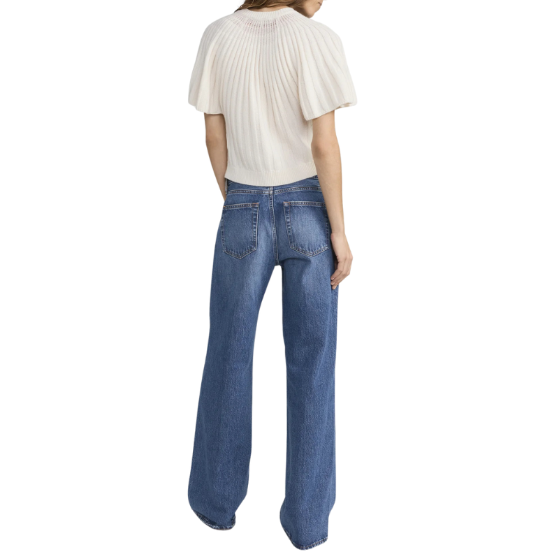 Person wearing a white blouse and blue jeans on a white background
