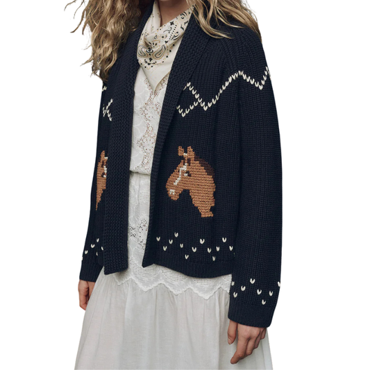 Navy blue cardigan with horse designs worn by a person on a white background