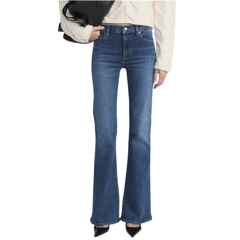 Person wearing blue flared jeans on a white background