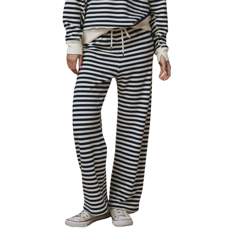 Person wearing a striped outfit with wide-leg pants on a white background