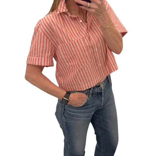 Person wearing a red and white striped shirt and blue jeans on a white background