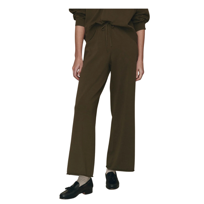 Brown pants worn by a person on a white background