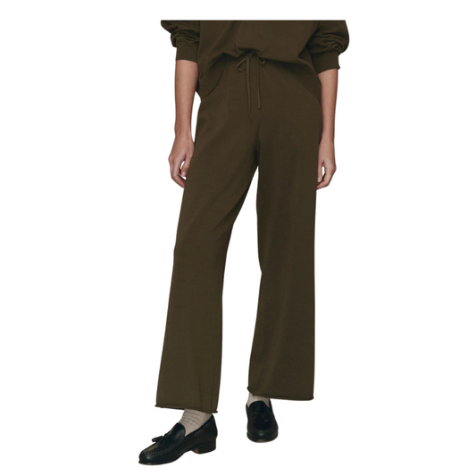 Brown pants worn by a person on a white background