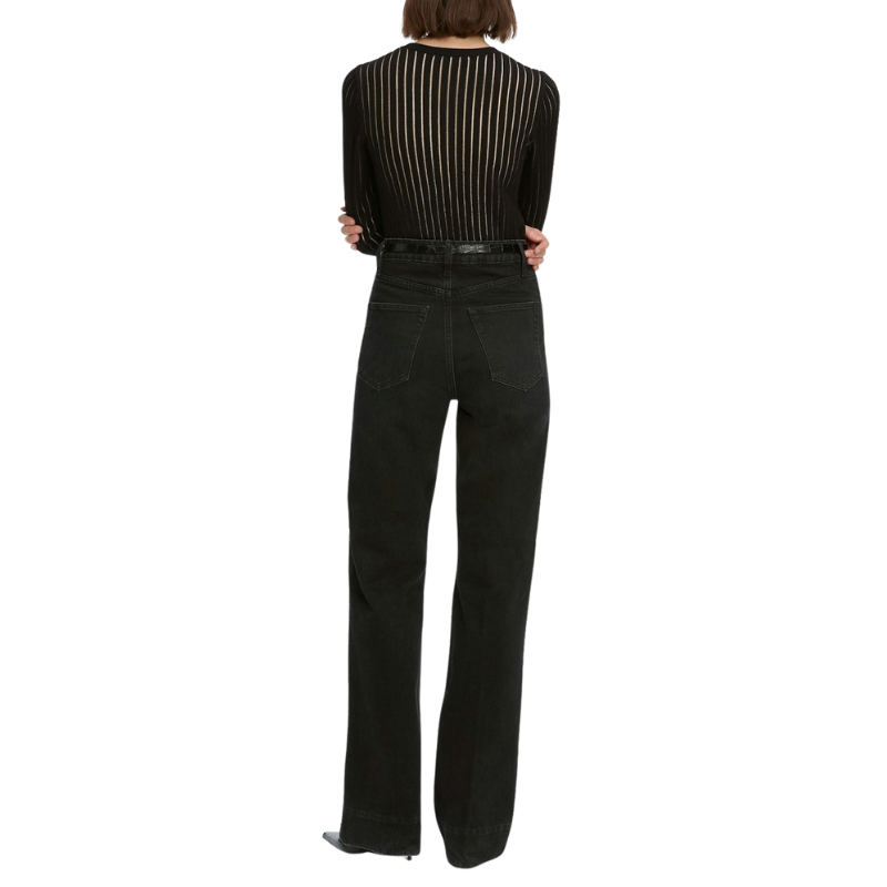 Person wearing a black outfit with a striped top and wide-leg pants on a white background