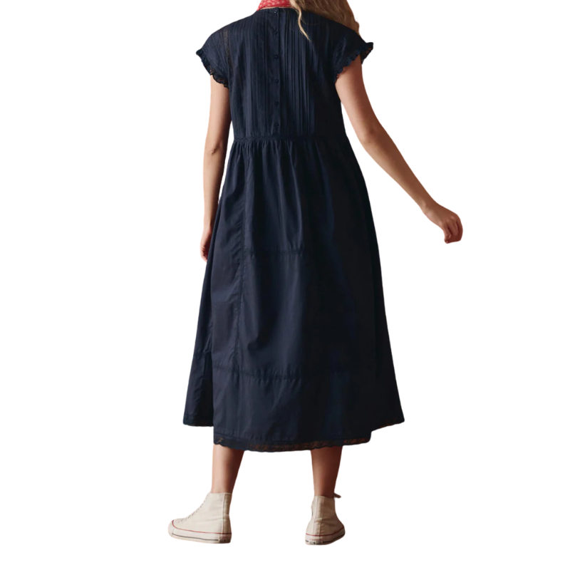 Person wearing a navy dress on a white background