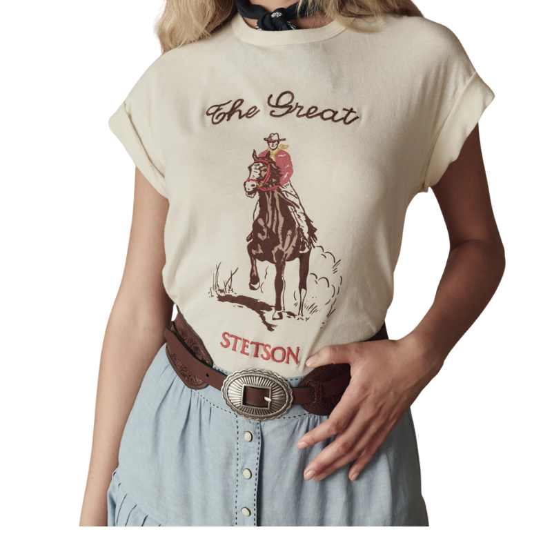 Person wearing a t-shirt with a horse and cowboy graphic and 'The Great Stetson' text.