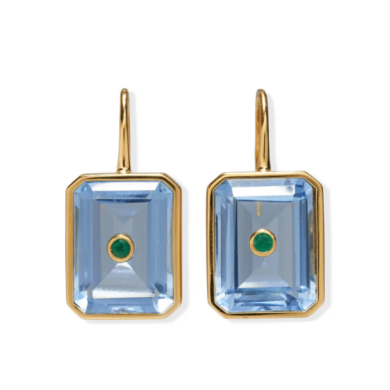 Pair of earrings with blue gemstones and gold frames on a white background
