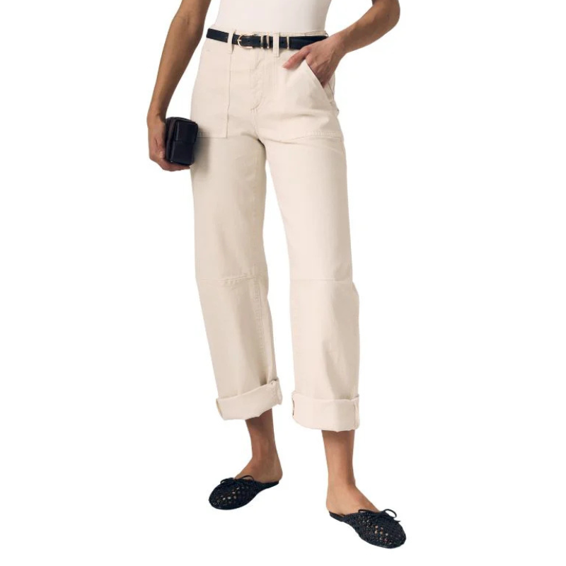 Person wearing beige pants with a white background