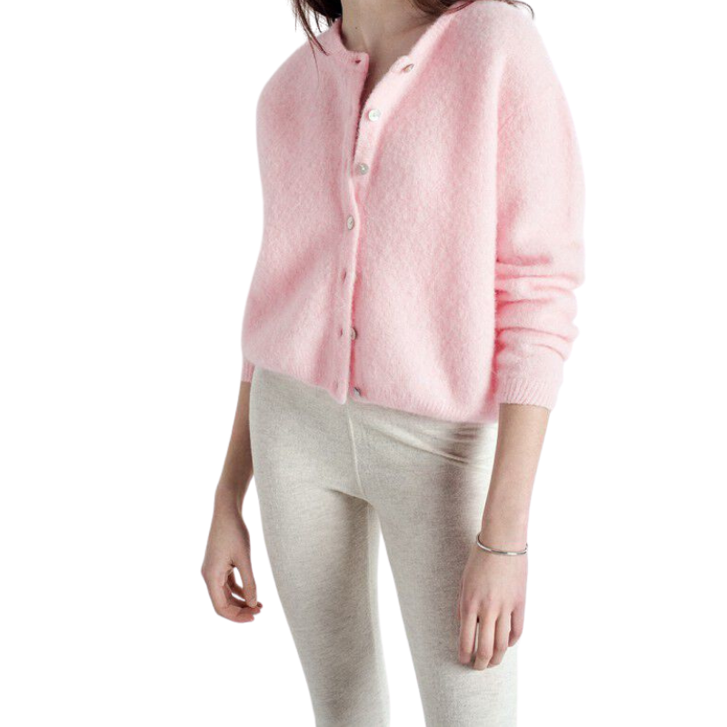 Person wearing a pink cardigan and light gray pants on a white background