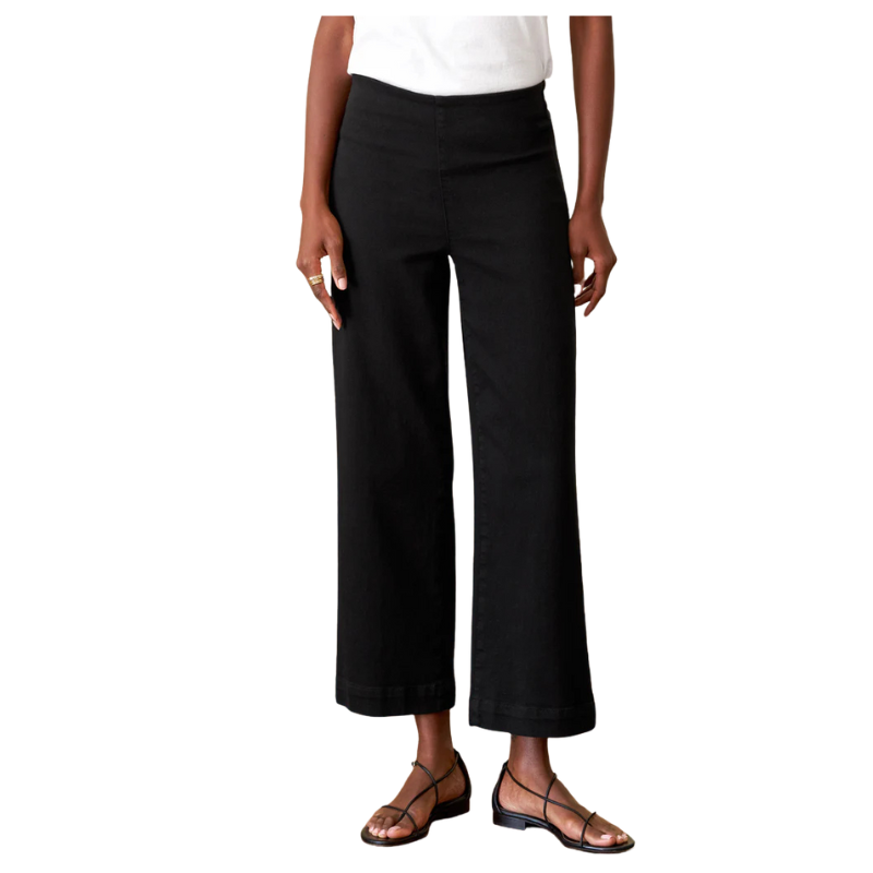 Person wearing black pants on a white background